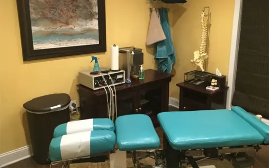 An adjustment room at Succasunna Chiropractic & Spine Rehab with an adjustment table and spine model for patient education